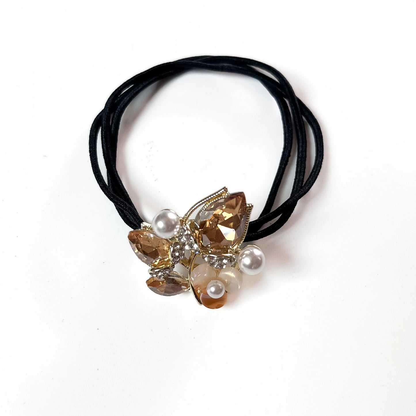 Champagne Gold botanical crystal hair tie with marquise leaf charm and pearl beads on black elastic