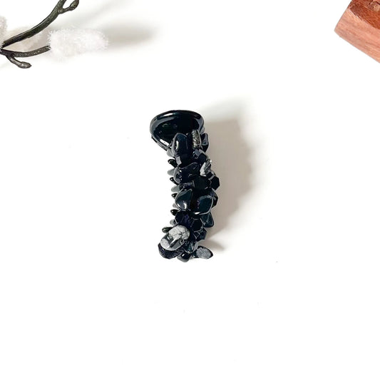 Black dainty mini banana clip with slim barrel and dark faceted bead embellishments in refined aesthetic.