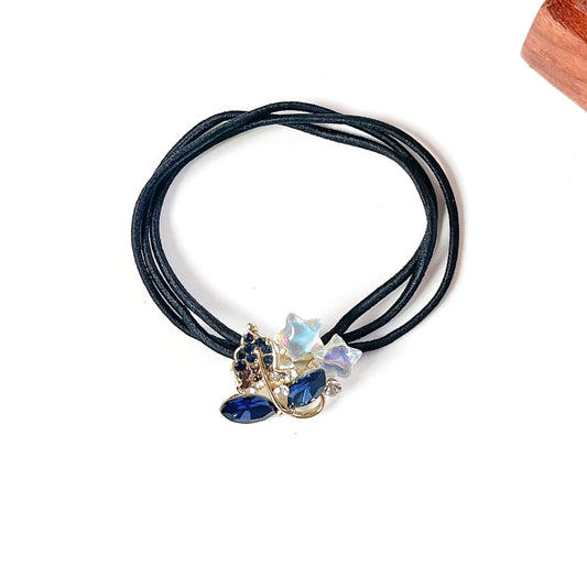 Denim blue jewelled hair tie with navy marquise crystals, blue rhinestone leaf and iridescent stars