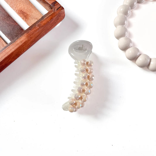 8cm cream banana clip with blush-pink faceted dome beads cascading down barrel and polished dome casing.