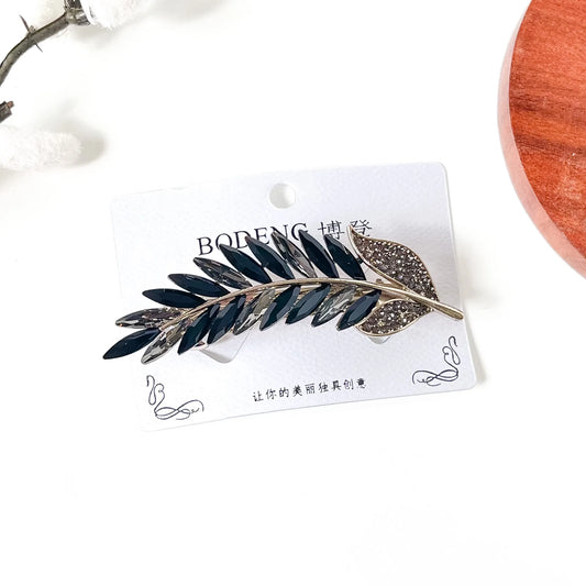 Noir black and smoky grey crystal feather barrette with pavé leaf, an elegant hair clip with stones