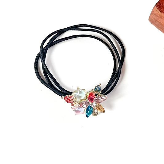 Holi multicolour fancy hair tie with pink, blue and peach crystal petals and pastel stars, jewelled hair elastic