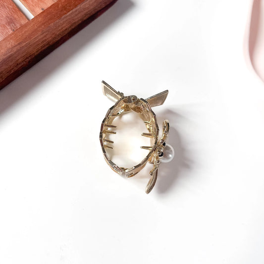 Back view of honeybee gold metal cuff hair tie showing inner grip teeth for ponytail hold