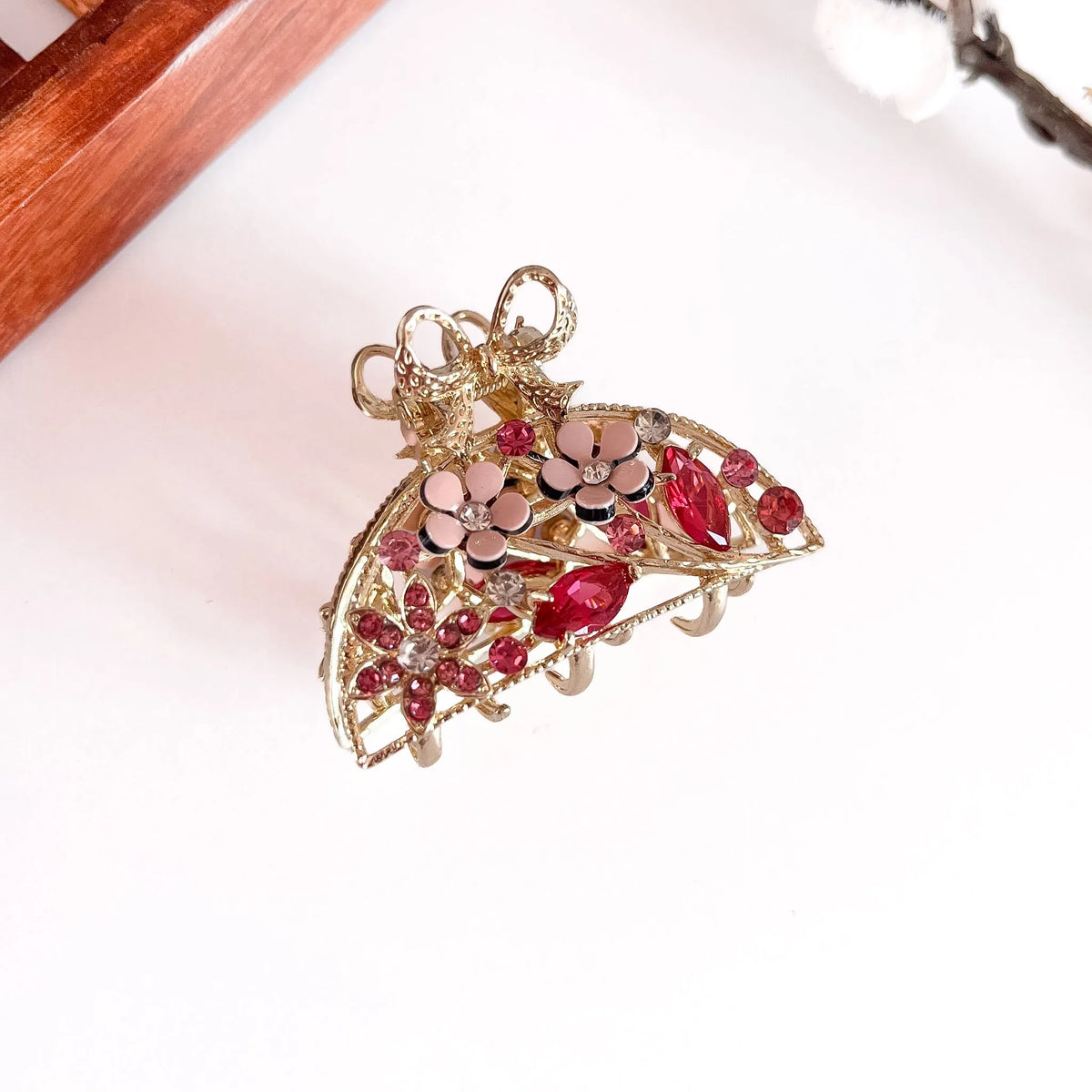 Red ornate pearl bow metal clip with filigree design and ruby gemstones, medium-thick hair clip