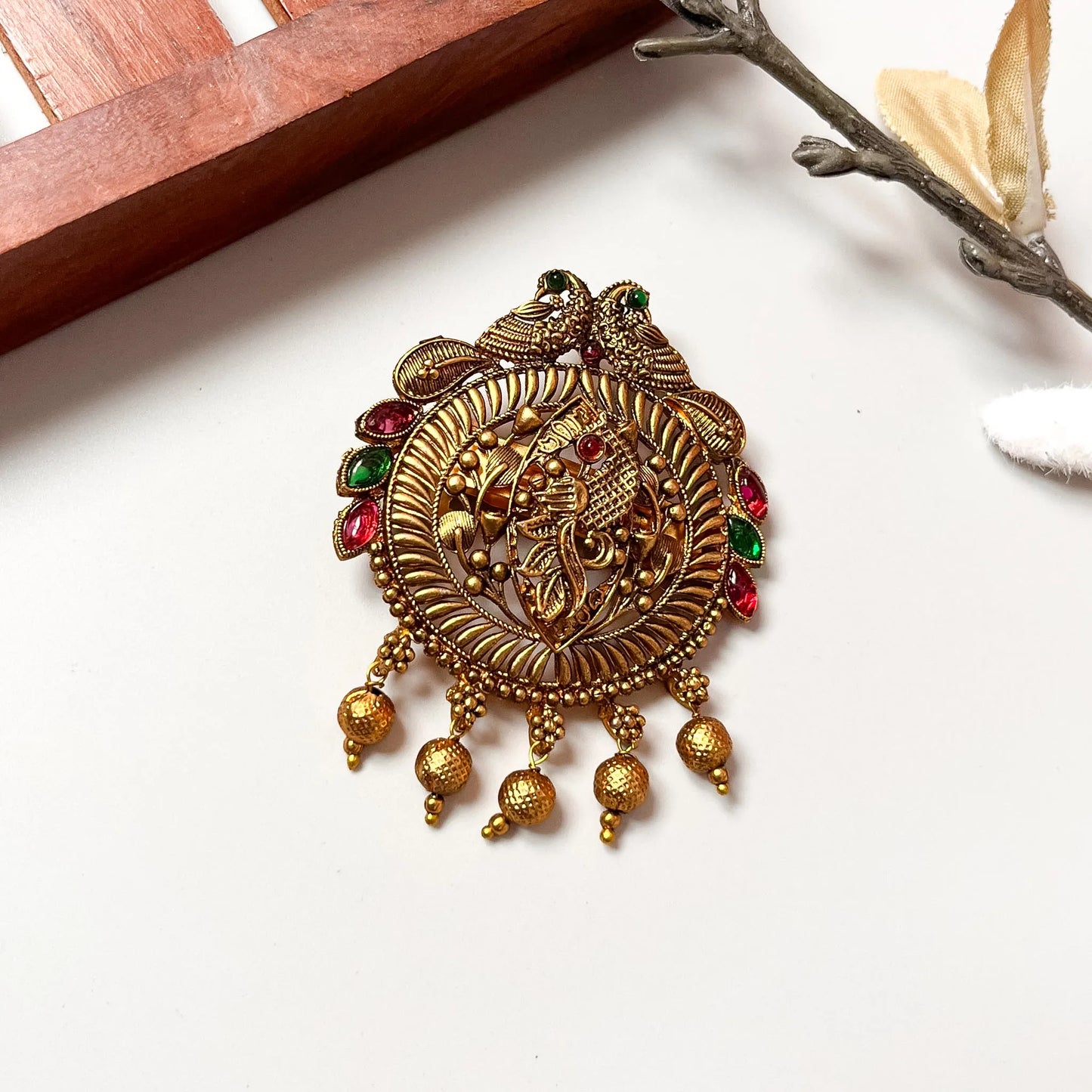 Regal peacock hair clip with mixed ruby and emerald stones, elaborate gold filigree design