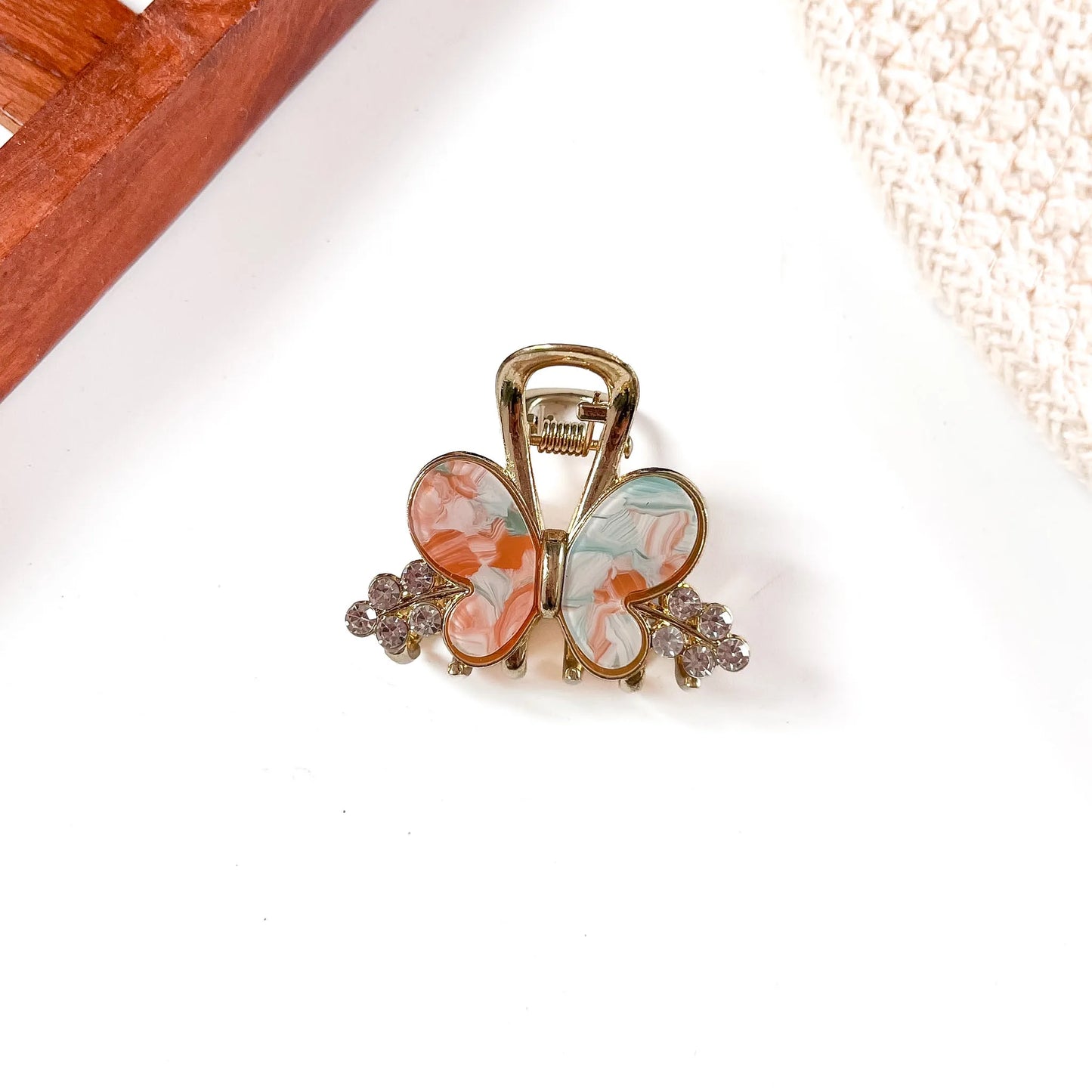 Coral and light blue resin butterfly metal claw clip with oversized wing detail and gold-tone metal frame with crystal bead sides.