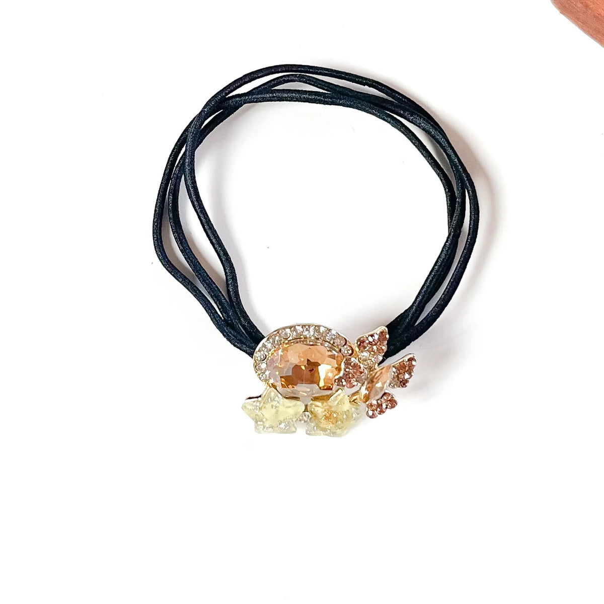 Toffee gold fancy hair rubber band with champagne oval crystal, rhinestone butterfly and yellow stars