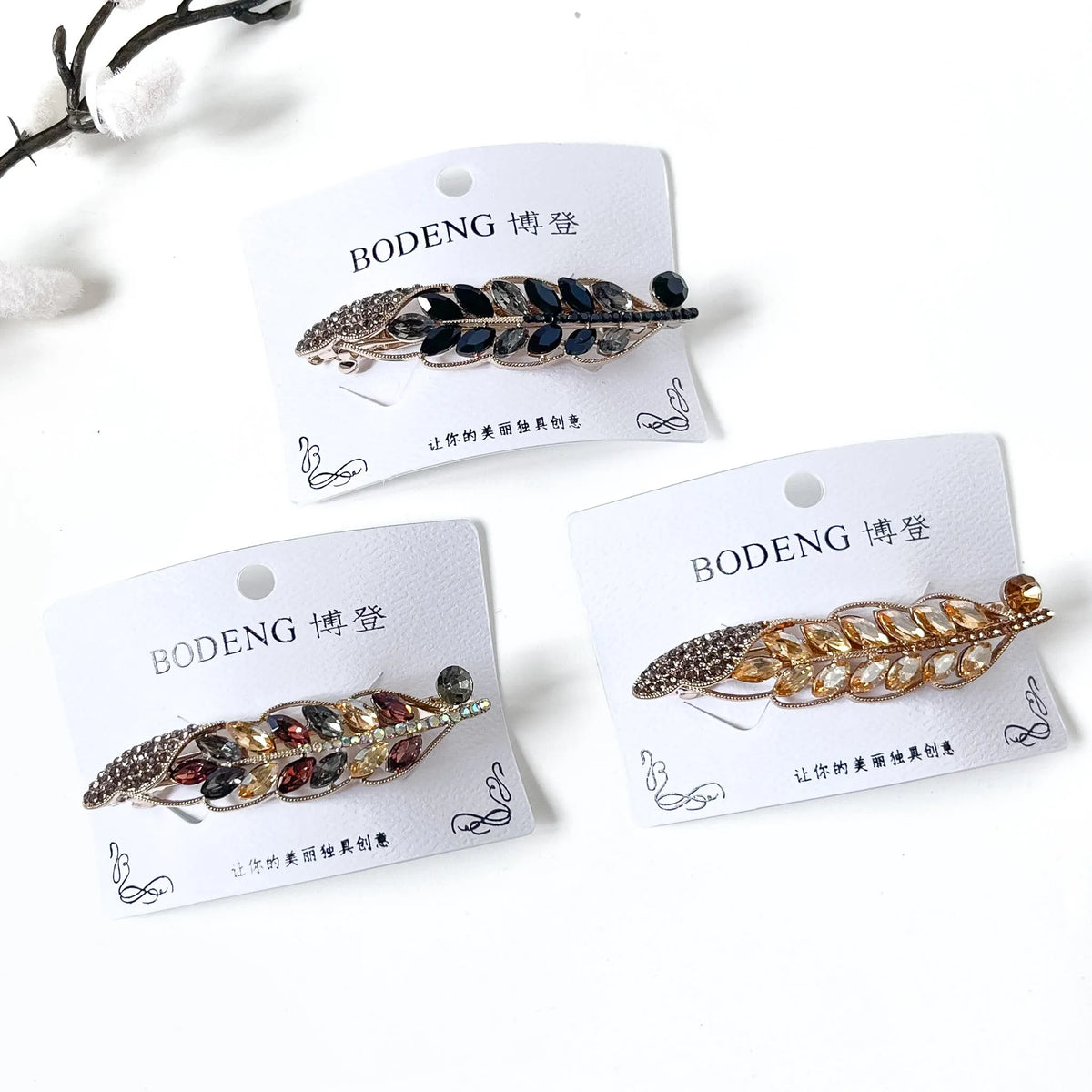 Autumn Crest crystal leaf barrettes in champagne gold, noir black and harvest multicolour