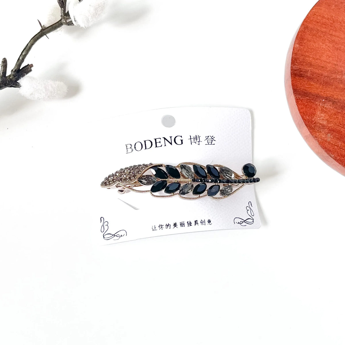 Noir black crystal leaf barrette with smoky grey stones and a black rhinestone stem, an elegant long hair clip