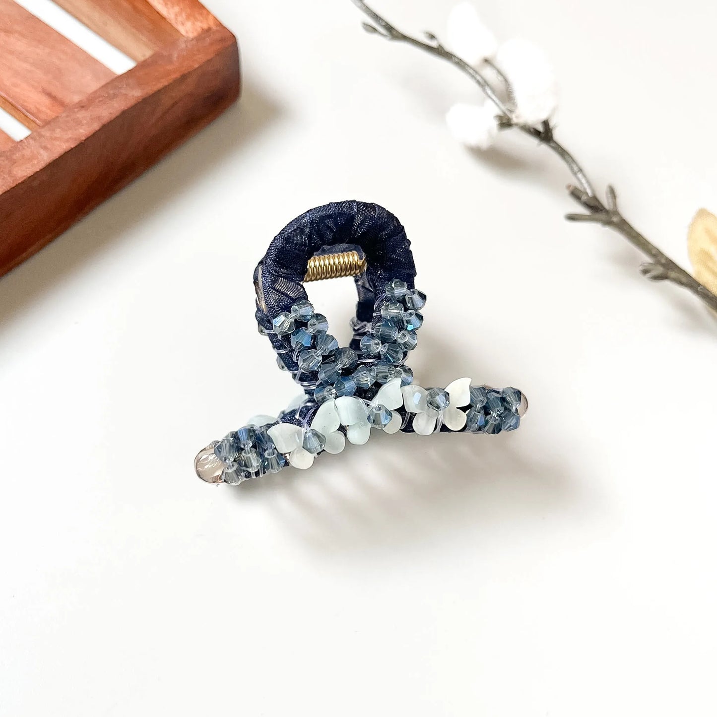 Navy beaded loop claw with frosted white crystal spheres, textured hair clip