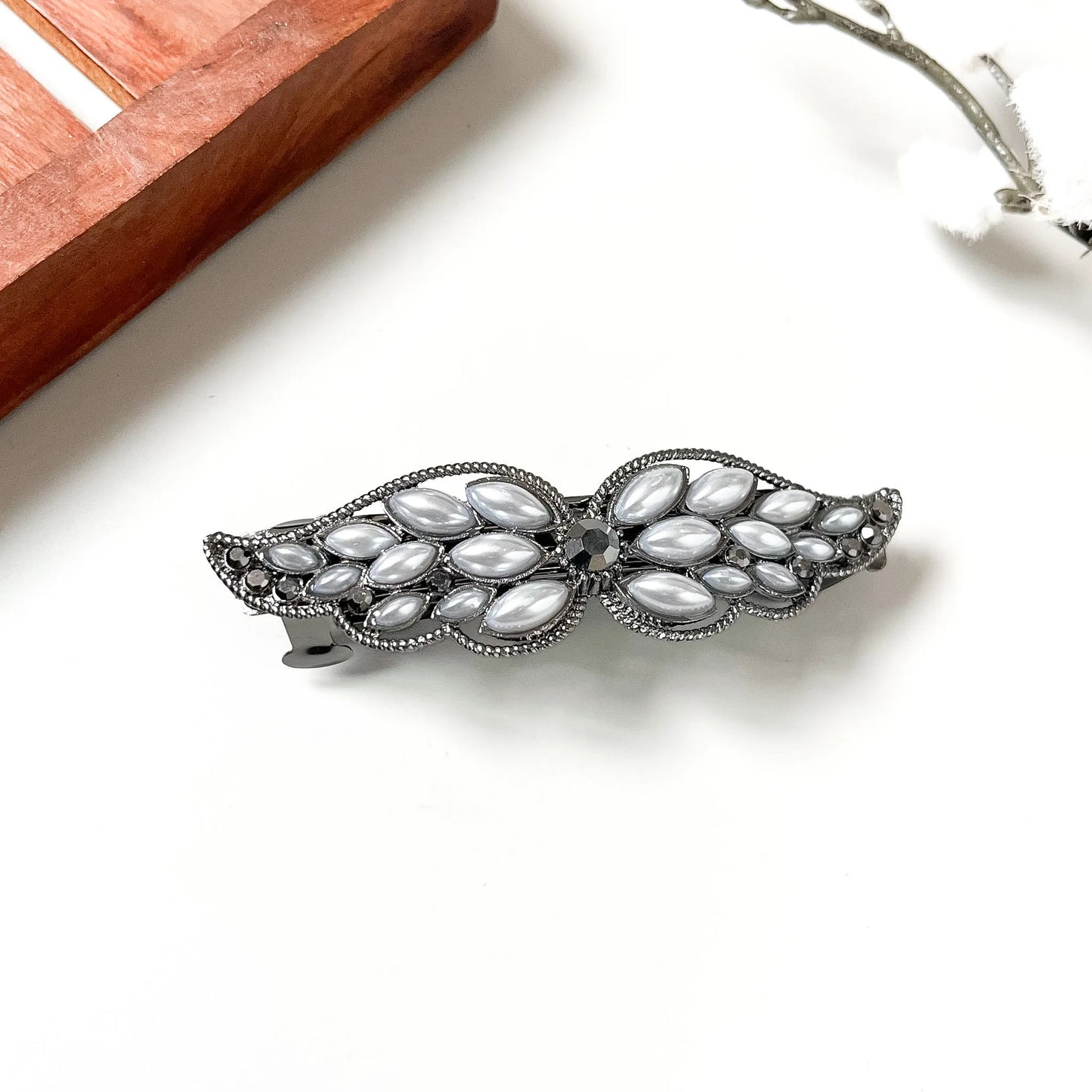 black pearl cabochon wing barrette with white ovals and rainbow centre accent, decorative hair clip