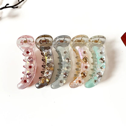 Blossom Crystal 8 cm rhinestone banana clips in blush pink, smoke grey, frost blue, peach beige and mint green with flower accents