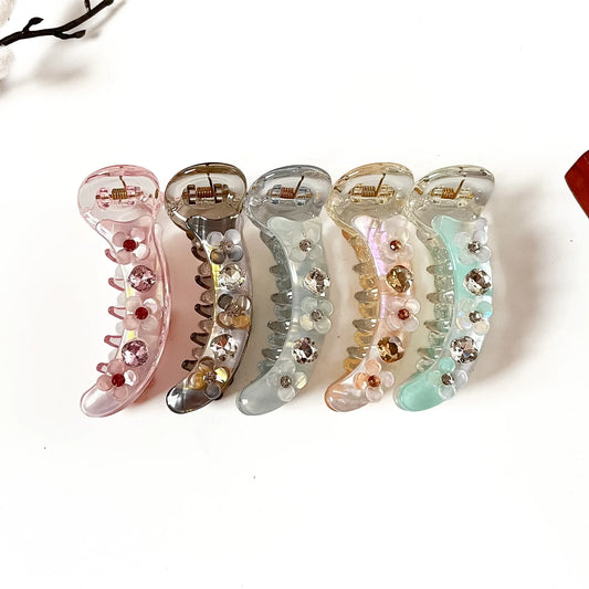 Blossom Crystal 8 cm rhinestone banana clips in blush pink, smoke grey, frost blue, peach beige and mint green with flower accents