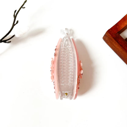 Blush pink teardrop banana clip with scattered rose rhinestones and white flower center, large size for thick hair