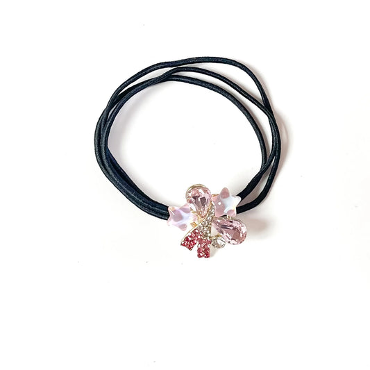 Blush pink fancy hair tie with teardrop crystals, star charms and rhinestone ribbon on black elastic