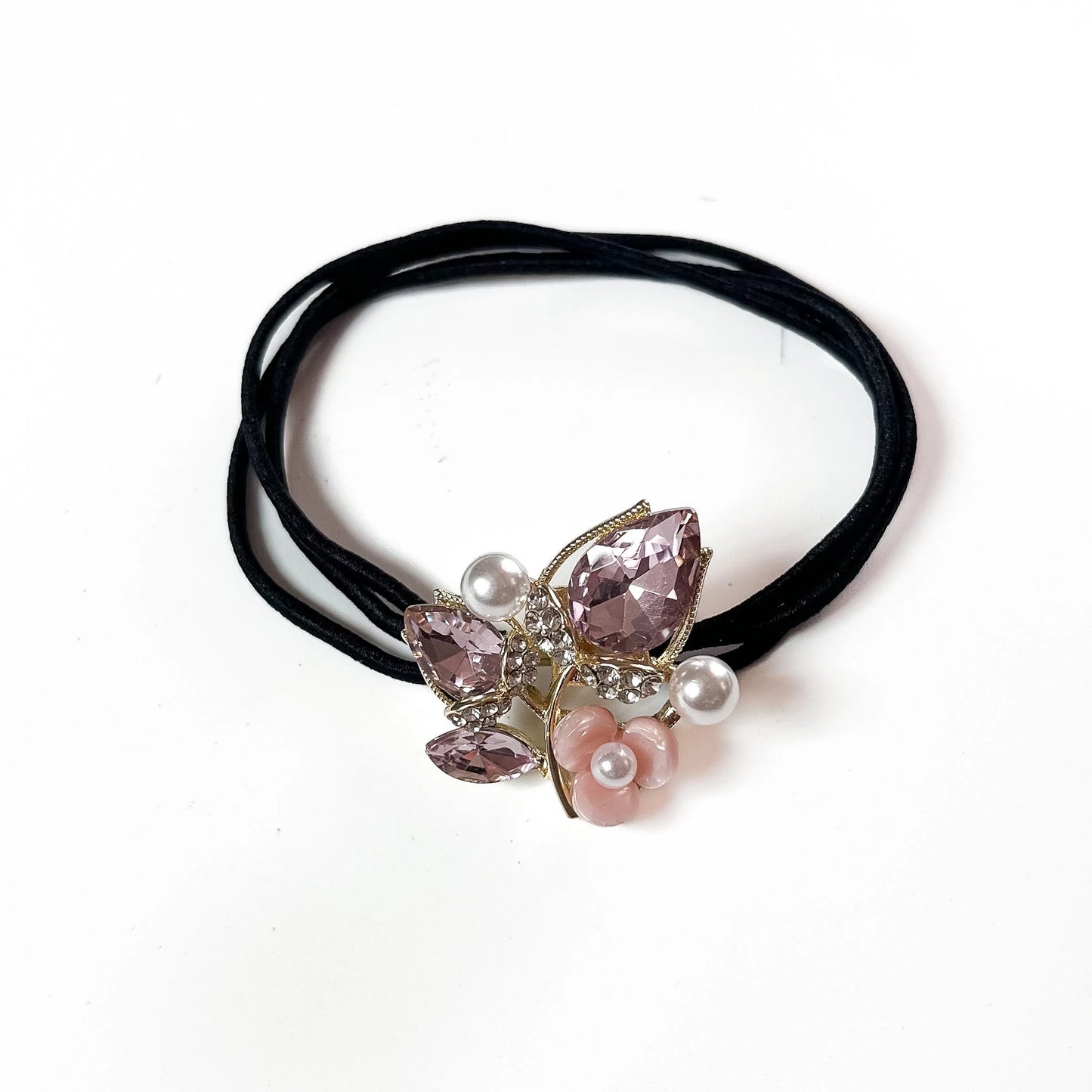 Blush pink botanical crystal hair tie with marquise leaf charm and pearl flower on black elastic band