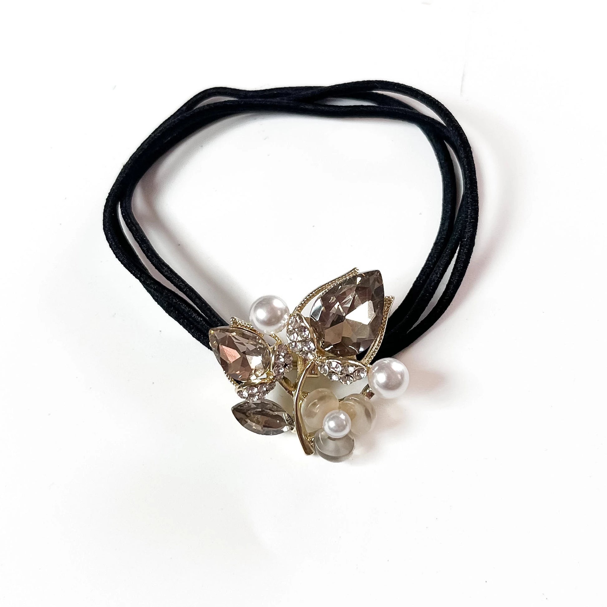 Silver botanical crystal hair tie with marquise leaf charm and pearl beads on black elastic band