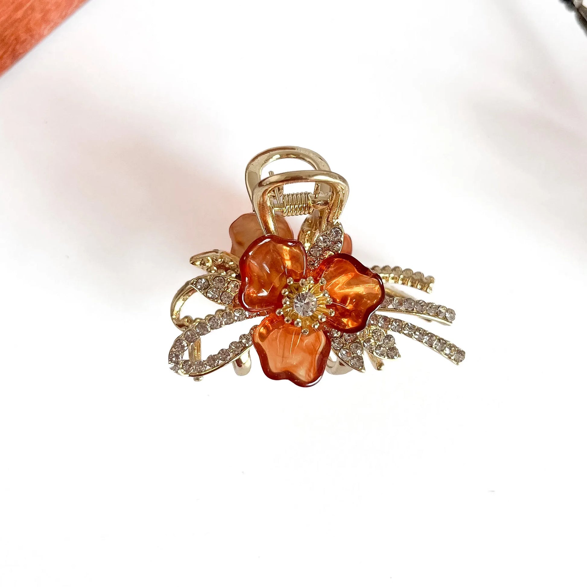 Rust orange botanical metal clip with filigree base and flower embellishment, medium