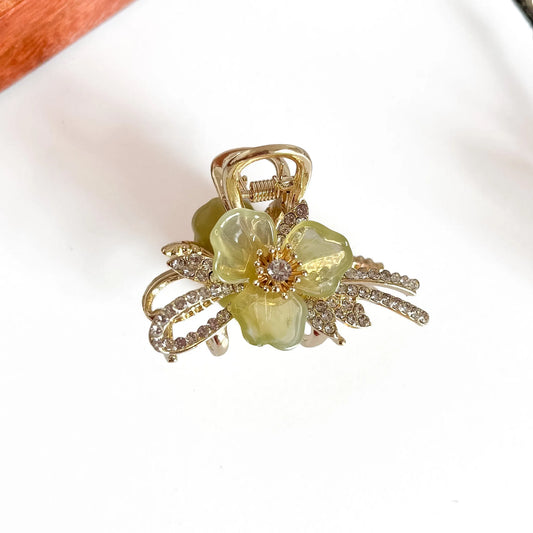Sage green botanical metal claw clip with rhinestone flower center, medium hair clip