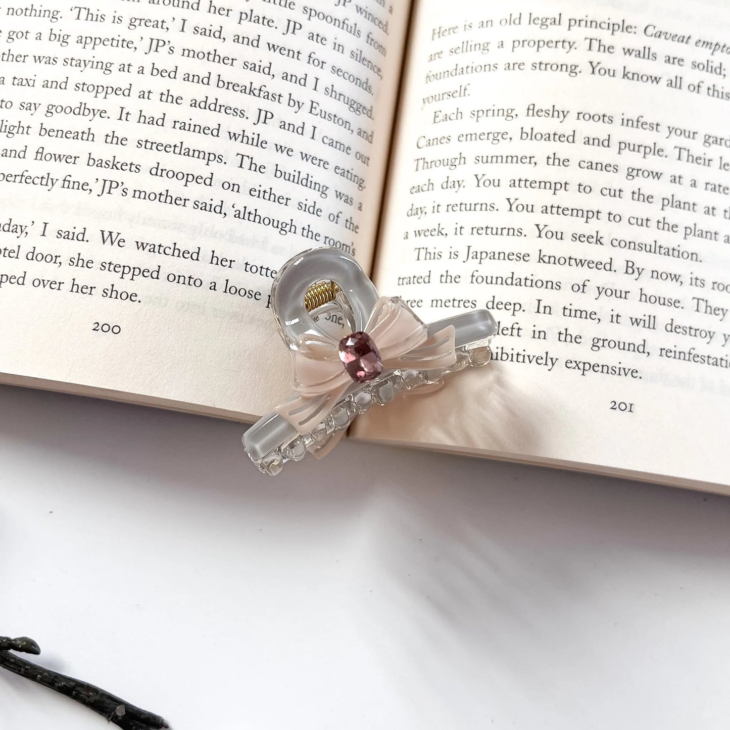 Pink and clear bow claw clip with pink gemstone accent