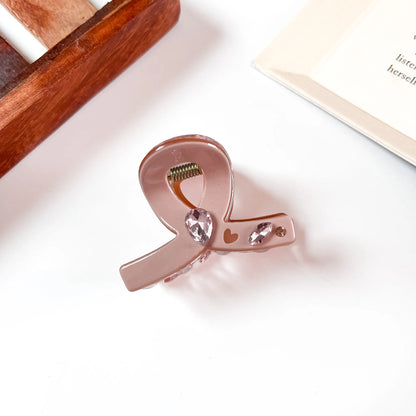 Blush pink bow claw clip with crystal and heart detail