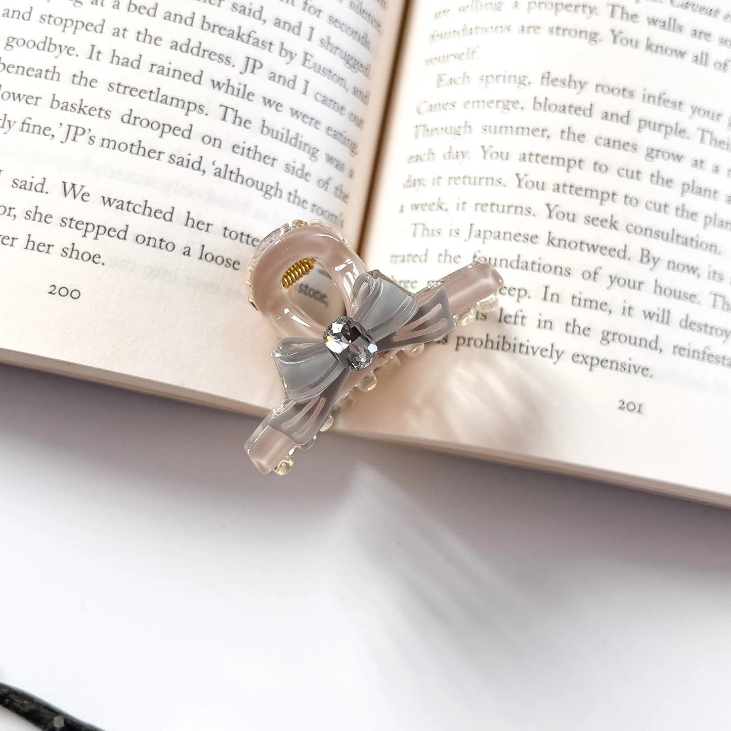 Grey and nude bow hair claw clip with rhinestone centrepiece