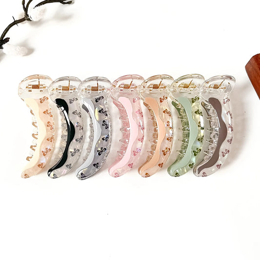 Bow Wave 8 cm bow print banana clips in cream beige, noir black, cloud grey, blush pink, peach orange, sage green and mocha brown
