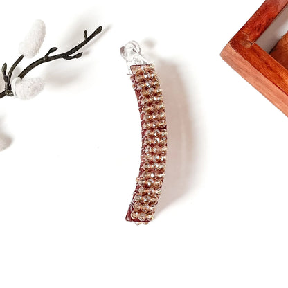 Champagne gold stone banana clip on maroon base for festive wear