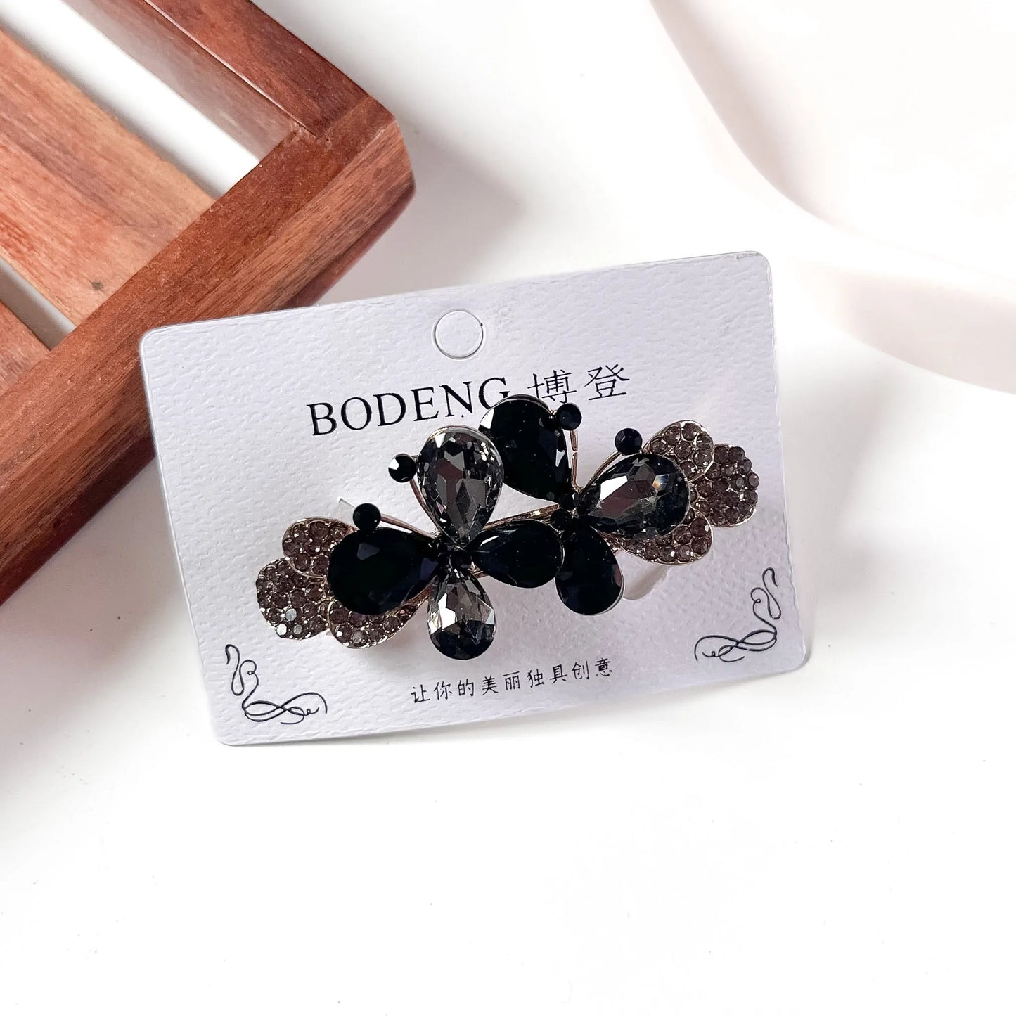 Black crystal butterfly barrette with rhinestone paved wings