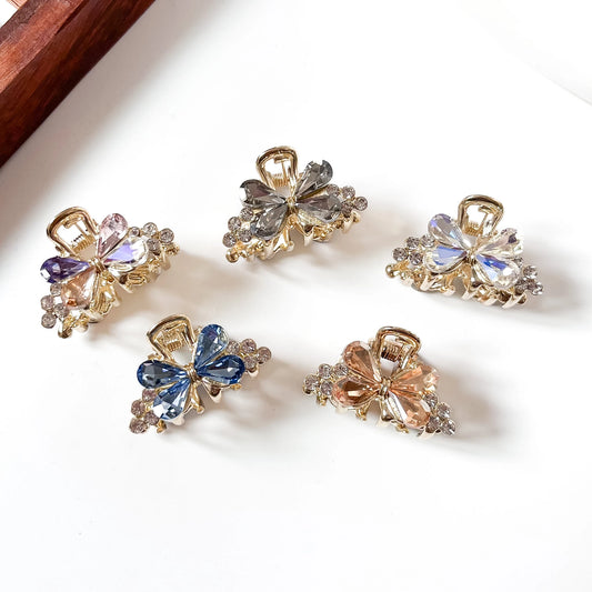 Crystal butterfly mini claw clips in purple, grey, clear, blue and champagne with rhinestone flower accents