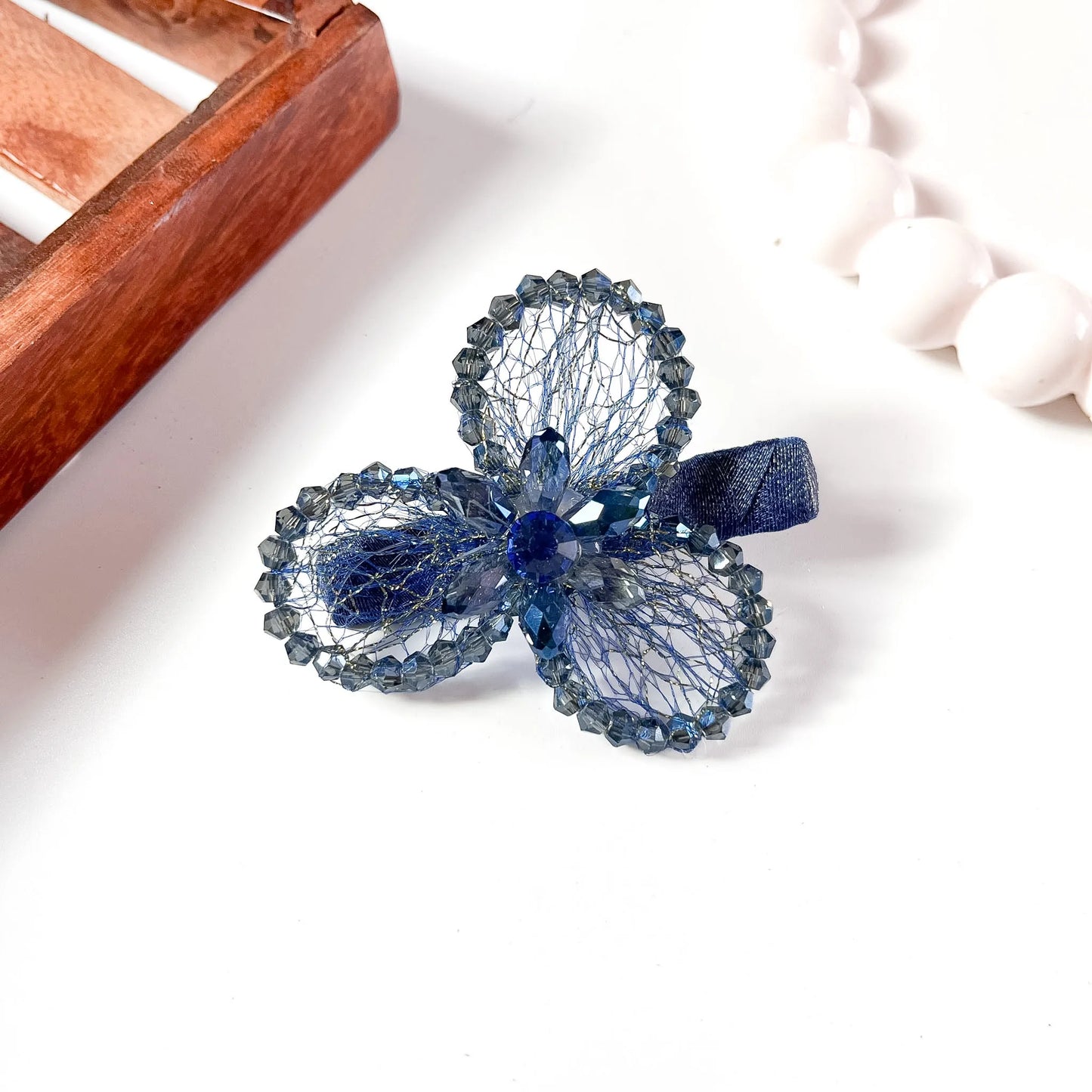 Blue mesh alligator clip with three crystal petal spheres and faceted beads