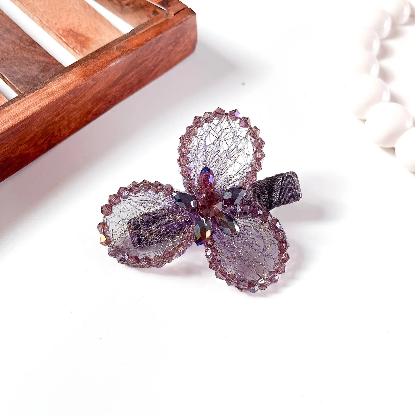 Mauve/purple mesh alligator clip with three crystal petal spheres,