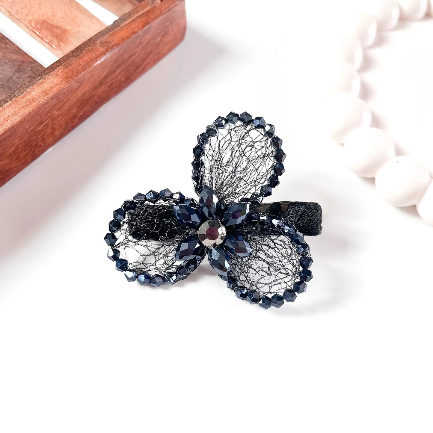 Black mesh alligator clip with three crystal petal spheres and faceted beads,
