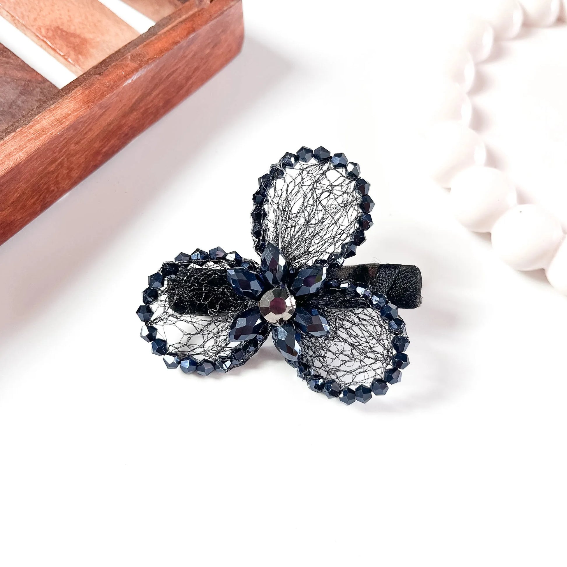 Black mesh alligator clip with three crystal petal spheres and faceted beads,