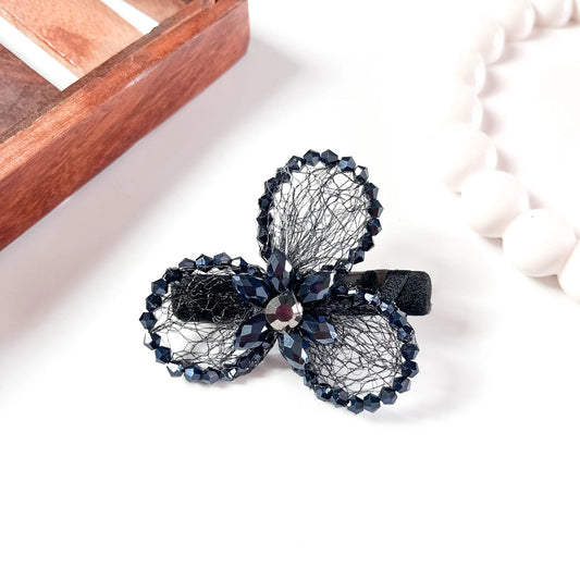 Black mesh alligator clip with three crystal petal spheres and faceted beads,