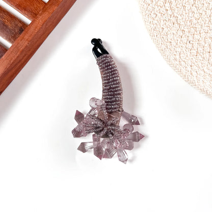 Soft mauve crystalline banana clip with subtle sparkle and lavender-tinted crystal accents.
