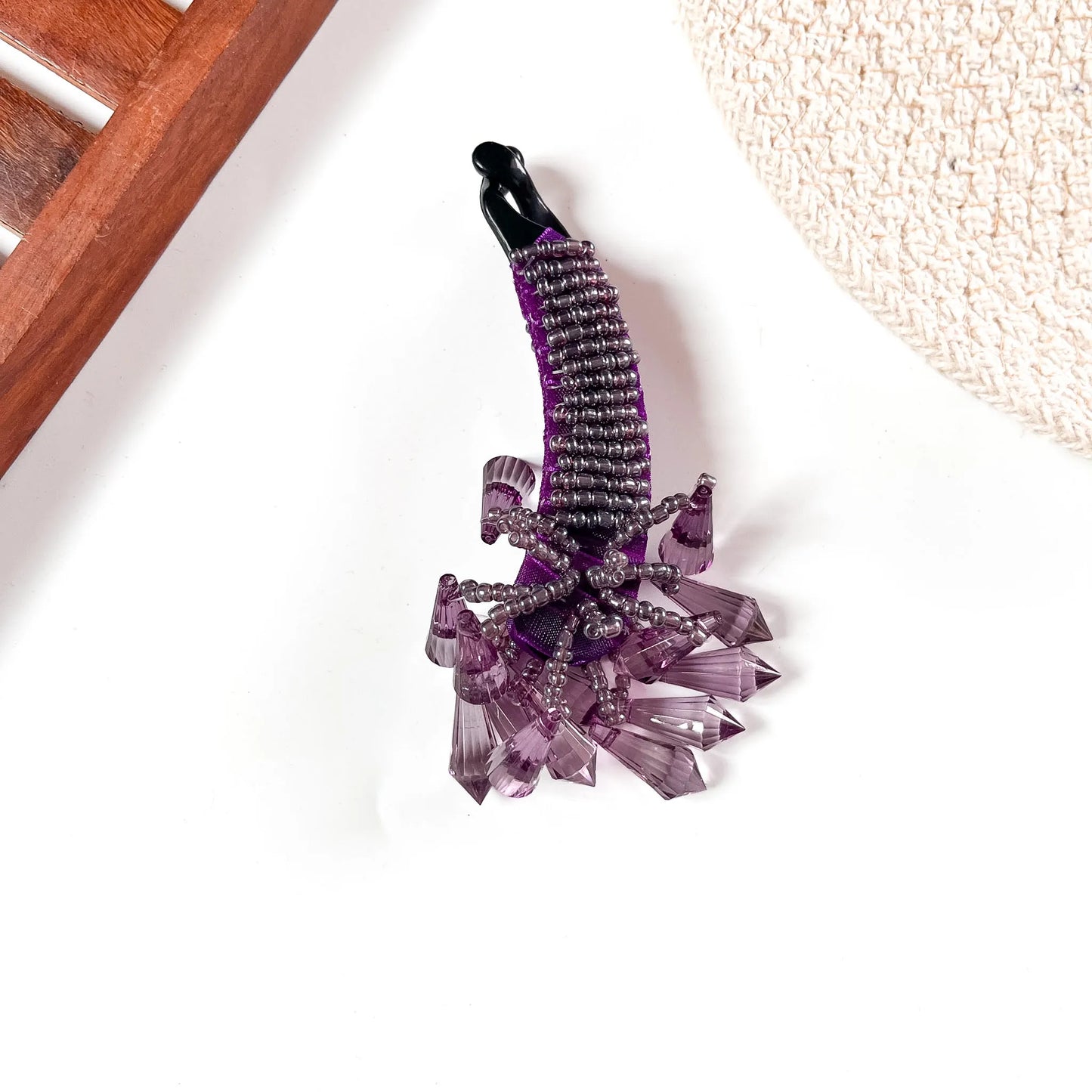 Vivid purple crystalline banana clip with faceted texture and amethyst-toned large crystal drops.