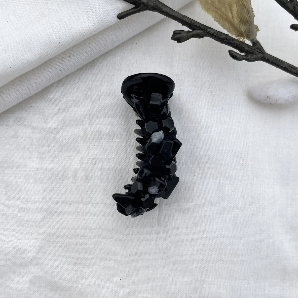 Black dainty mini banana clip with slim barrel and dark faceted bead embellishments in refined aesthetic.