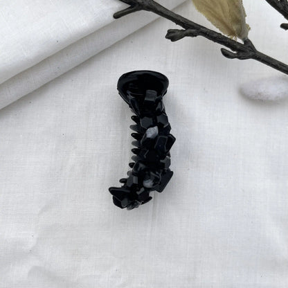 Black dainty mini banana clip with slim barrel and dark faceted bead embellishments in refined aesthetic.