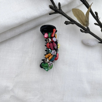 Playful multicolor dainty mini banana clip with mixed-hue beads in red, pink, orange, yellow, green, and purple accents.