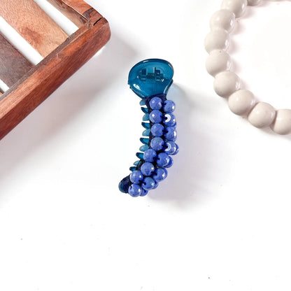 Cobalt blue dome bead banana clip featuring glossy barrel and deep purple faceted dome bead detailing throughout.