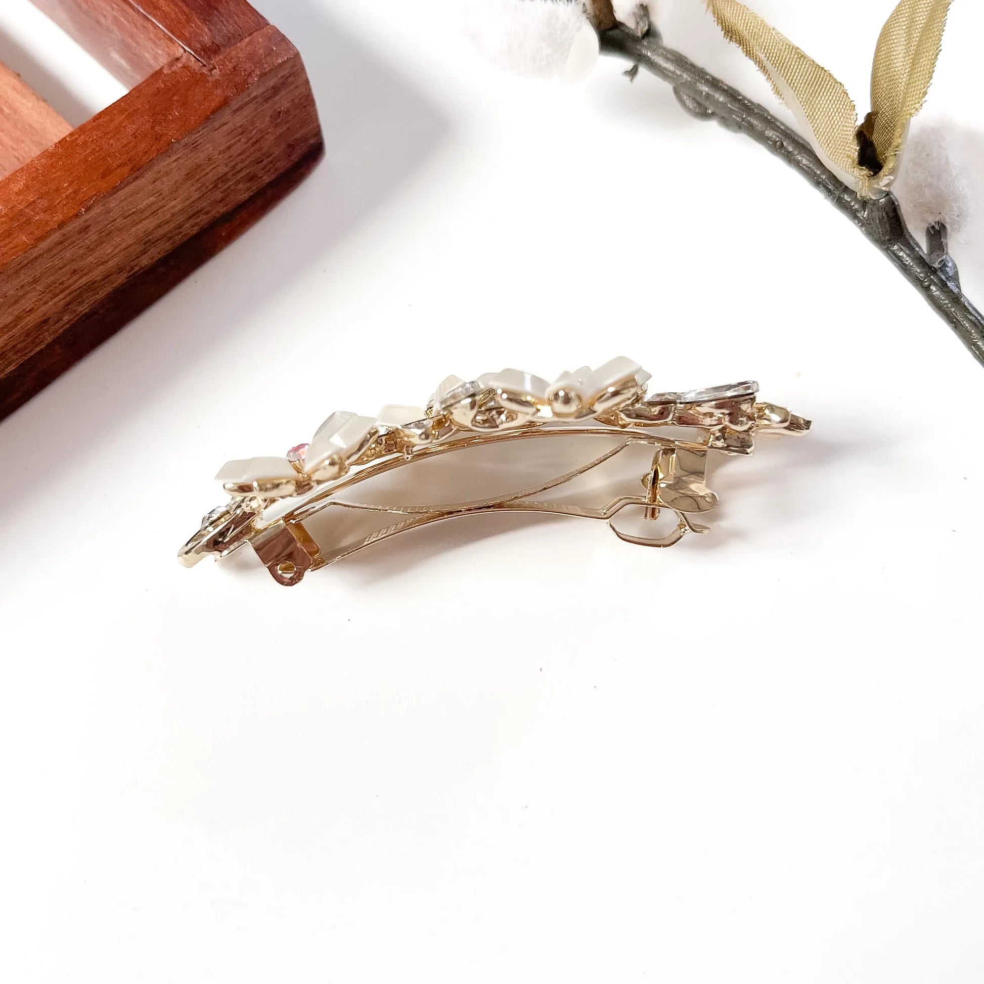 Back view of floral gold barrette showing French clasp mechanism