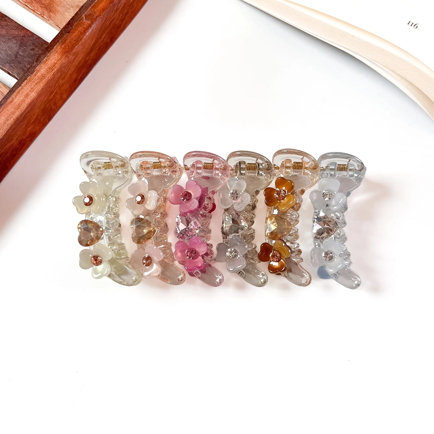 Color swatch: all 6 mini flower gem banana clip shades in a row