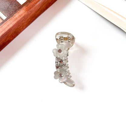 Clear mini banana clip with floral gems and sparkling rhinestone details, 6cm