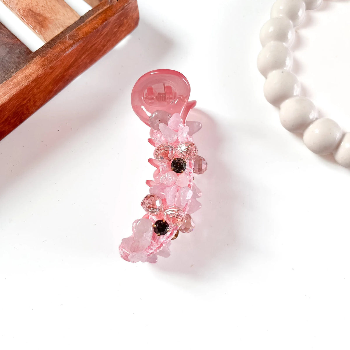 Soft blush pink glam chunk banana clip featuring chunky rose-tinted faceted gemstones with translucent finish.
