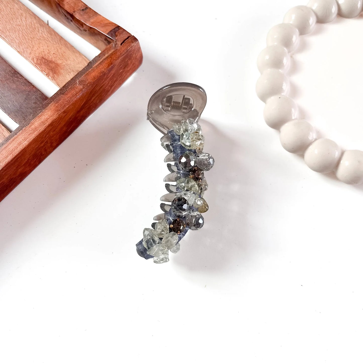 Smoky gray glam chunk banana clip with chunky faceted gemstone embellishments in mixed sizes creating textured sparkle.