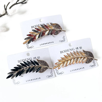 Golden Sheaf crystal feather barrettes in champagne gold, noir black and harvest multicolour