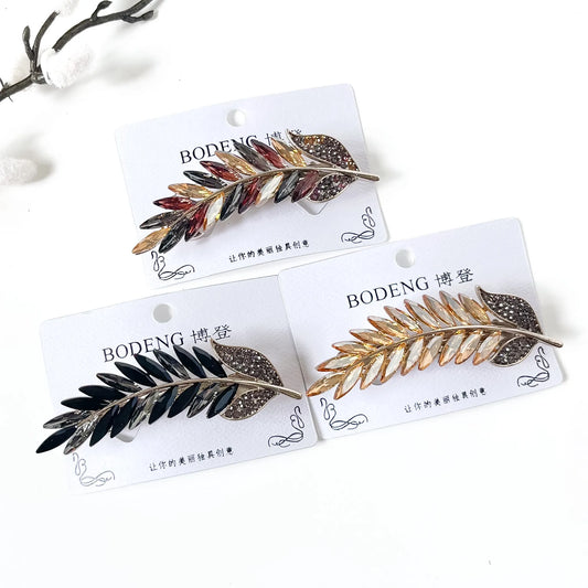 Golden Sheaf crystal feather barrettes in champagne gold, noir black and harvest multicolour