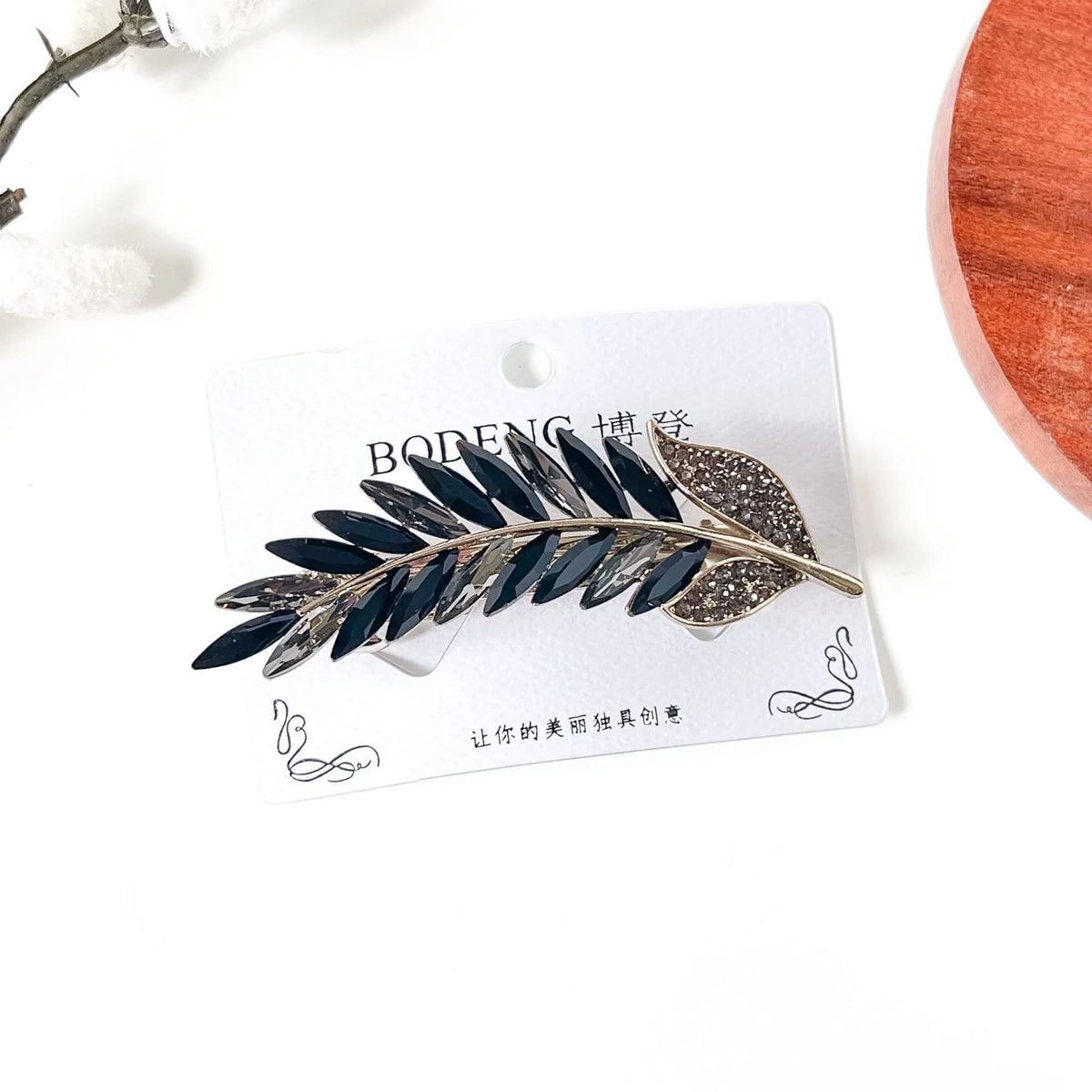 Noir black and smoky grey crystal feather barrette with pavé leaf, an elegant hair clip with stones