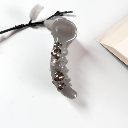 Grey matte banana clip with heart-cut crystals for women